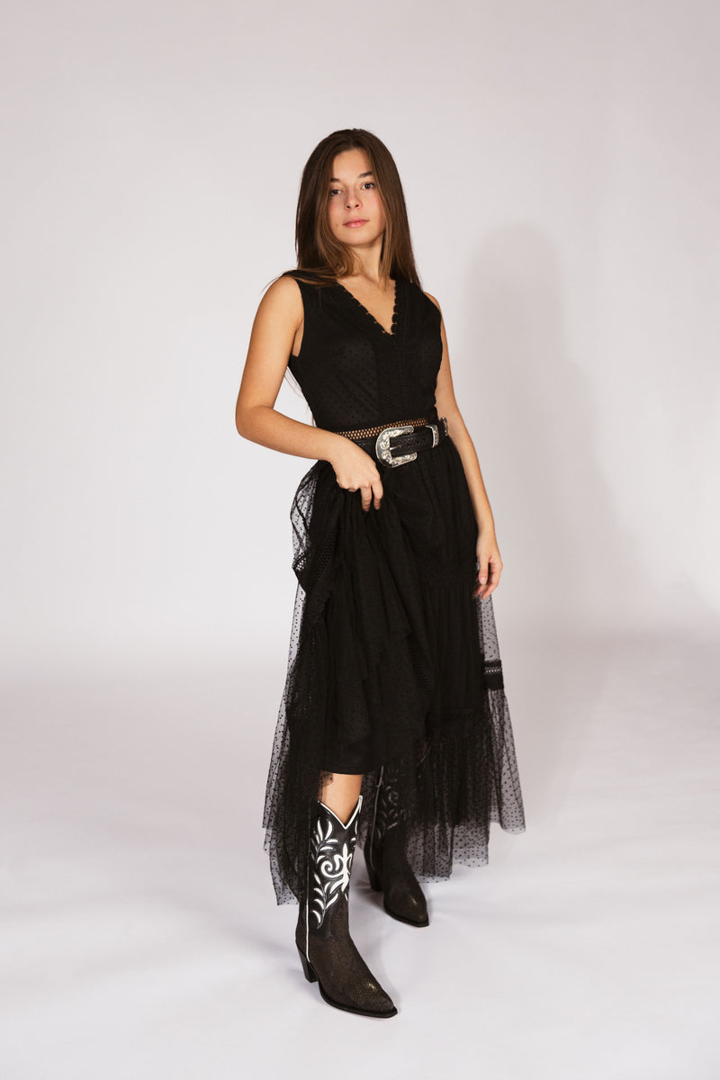 Woman wearing a black dress with sheer overlay and  handmade stingray black boots-RockiesRebels